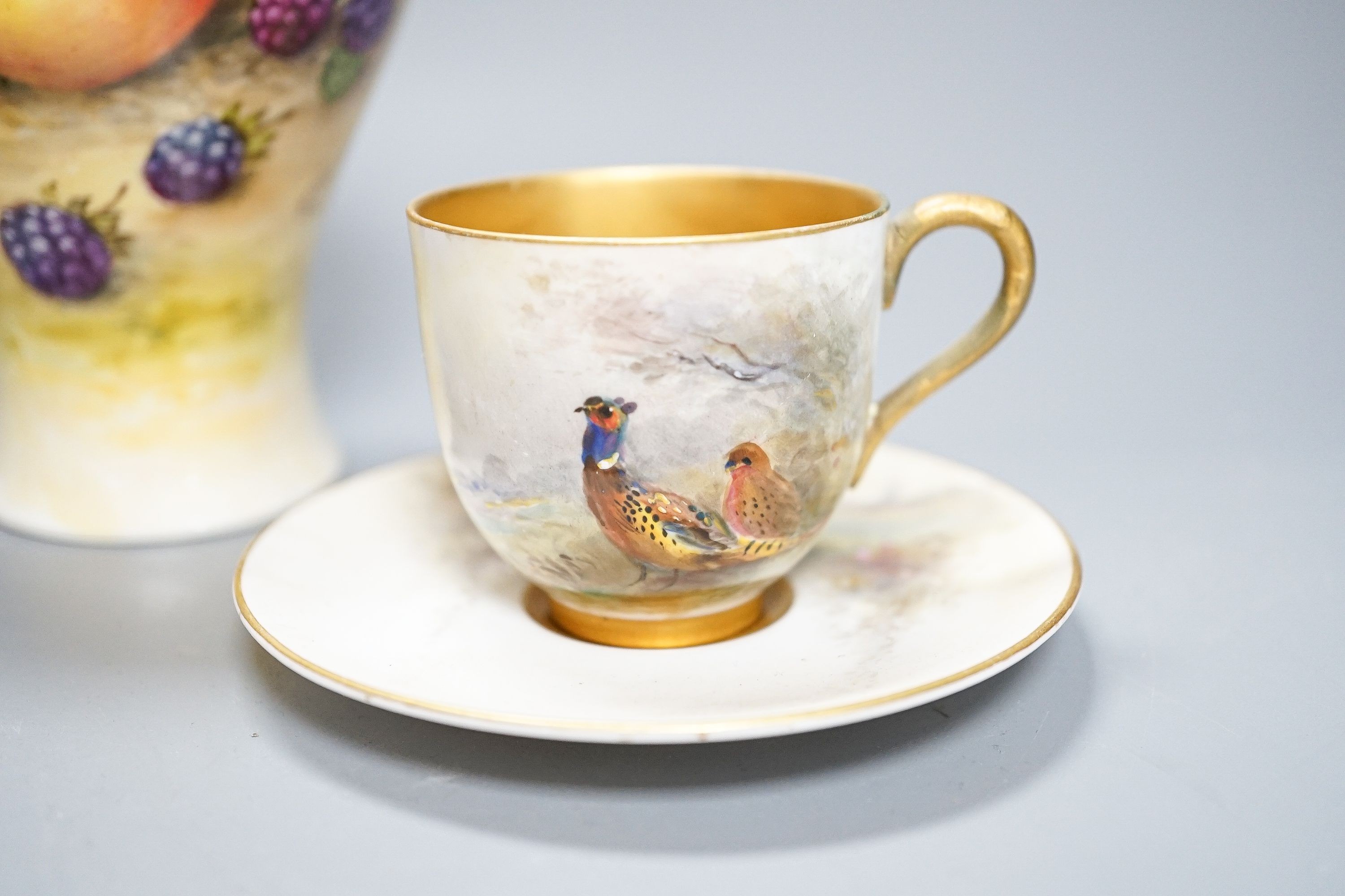 A Royal Worcester fruit painted small pot pourri and cover, 10.9cm high and a similar vase, 15cm, a Royal Worcester miniature cup and saucer, painted with pheasants, signed James Stinton and Grainger & Co pheasant vase